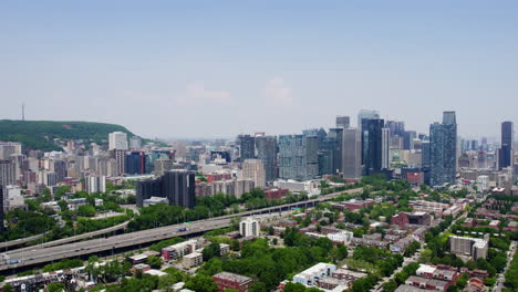 aerial tracking shot in front of the skyline of sunny montreal, quebec, canada