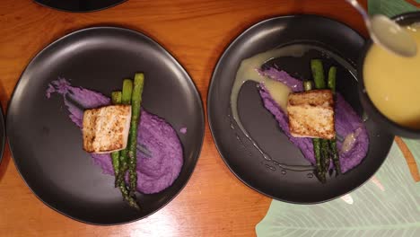 top down overhead view of chef saucing a plate