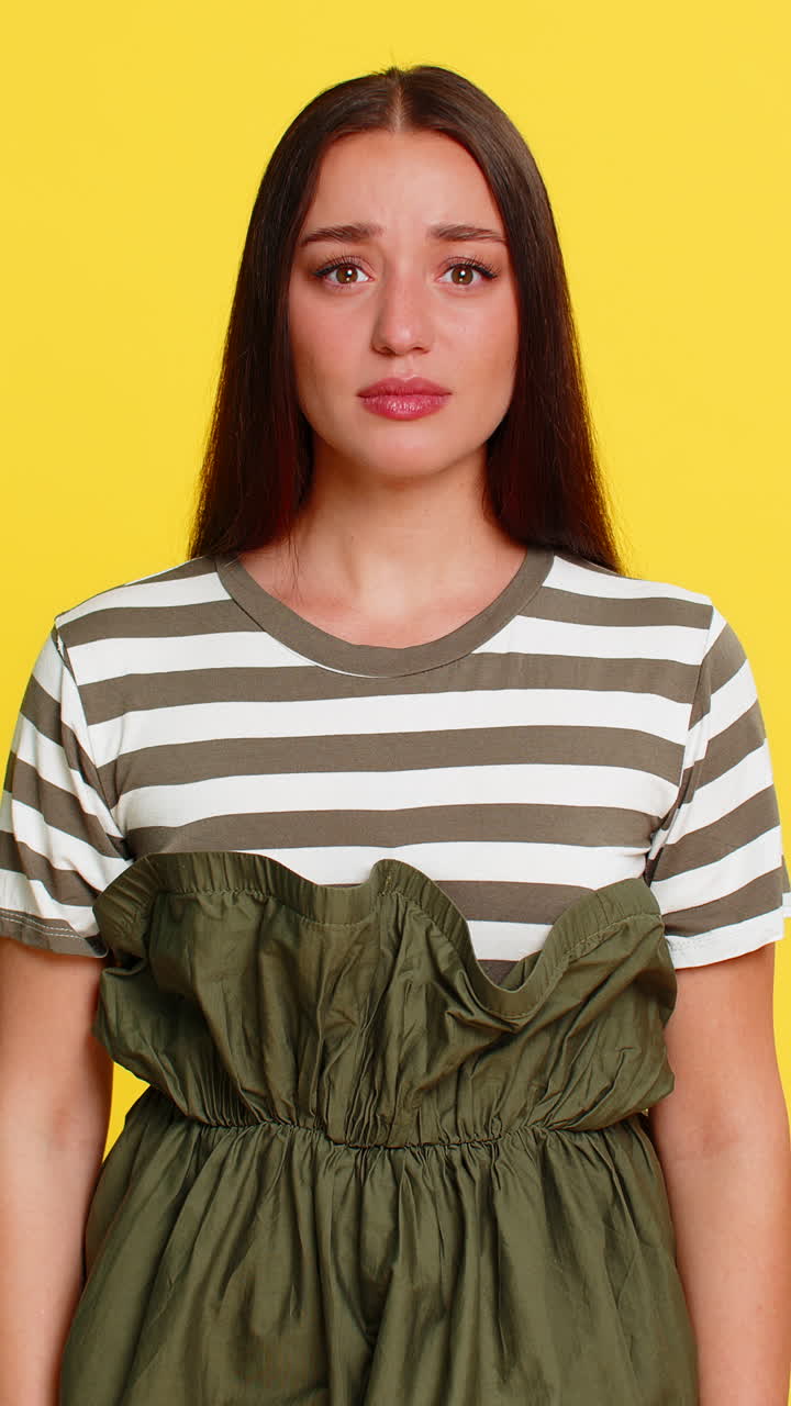 Woman tapping finger on temple with sarcastic expression showing disbelief silly irrational decision