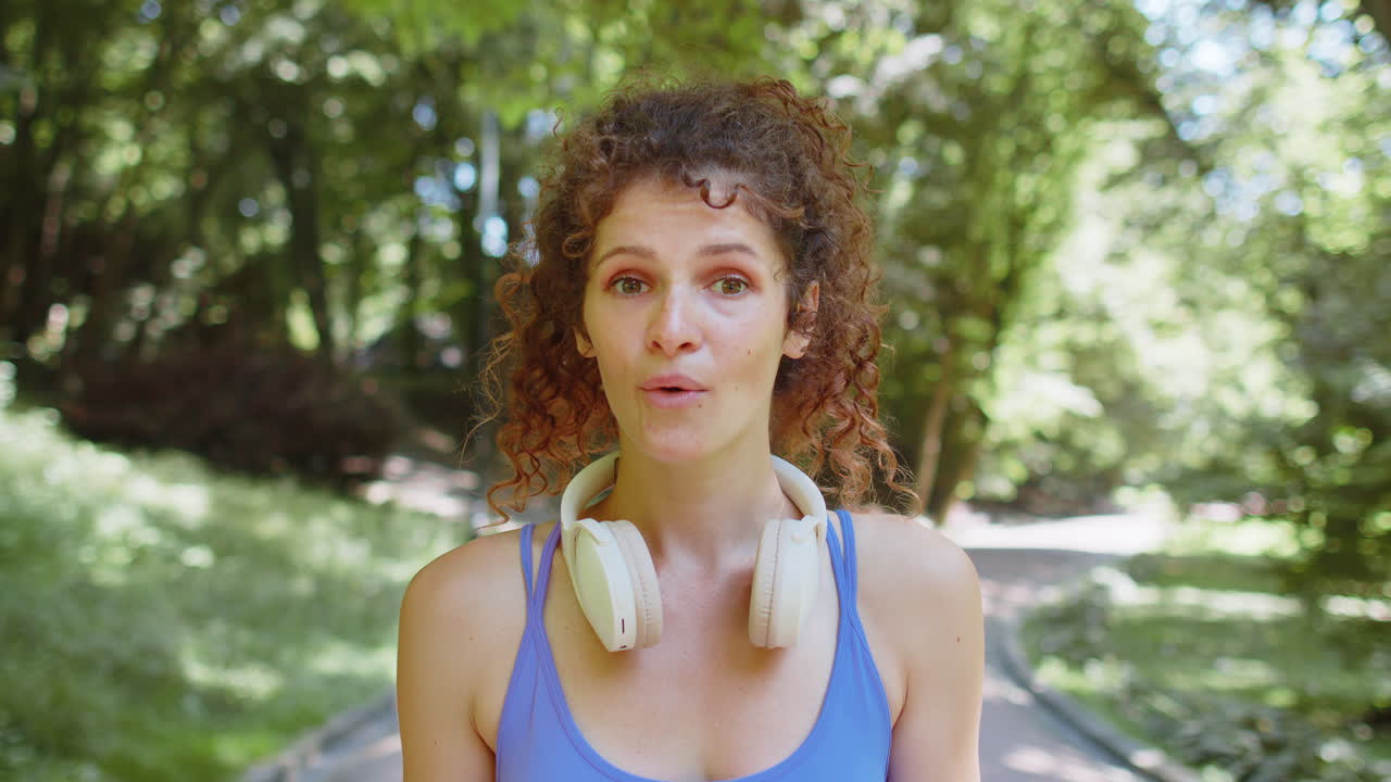 Athletic shocked excited fitness runner girl cover mouth in surprise looking at camera with big eyes