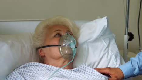 nurse putting oxygen mask on patient