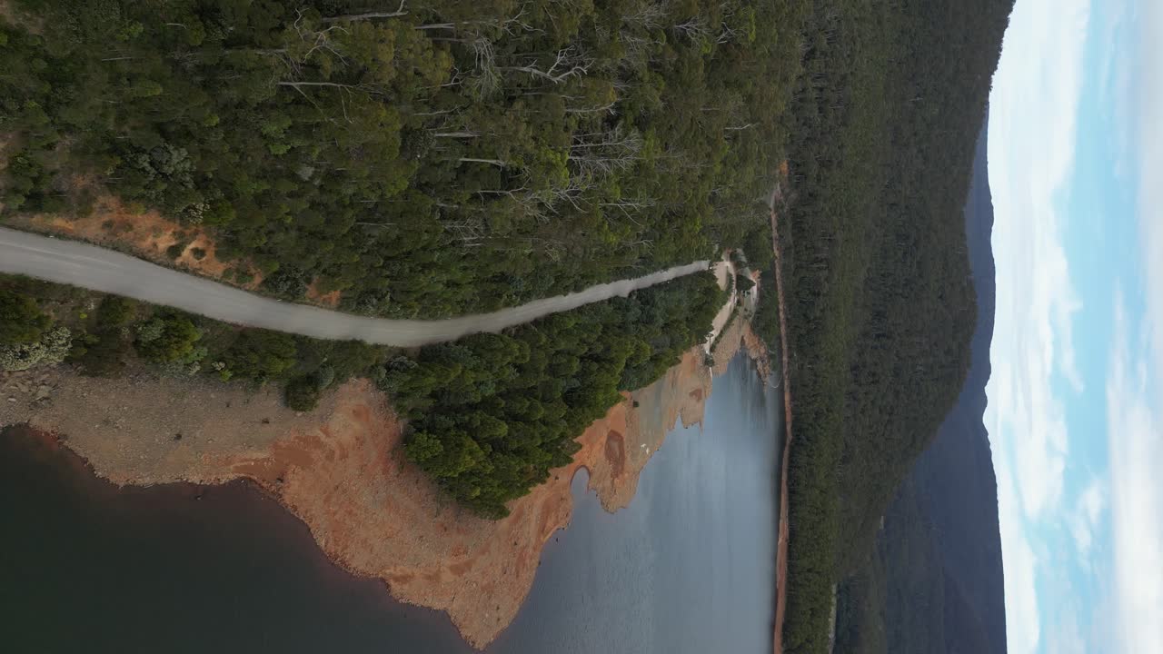 Aerial view over a rural road on the shores of lake Huntsman in Tasmania