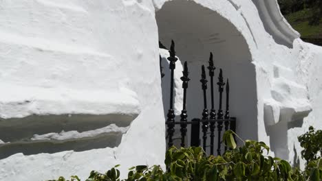rustic columns with capitals in the entrance in a white andalusian cemetery