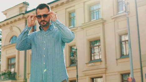 man in striped shirt on city street