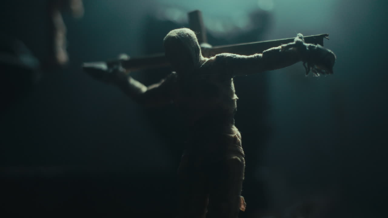 A miniature mummified dolls hanging on the gallows at night