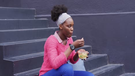 African-american-eating-a-salad-in-street