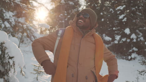 man hiking in a snowy forest