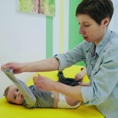 professional pediatrician examining infant