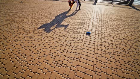 couple is dancing on pavement. legs of two dancers moving together outdoors. professional dancers performing freestyle dance in the street.