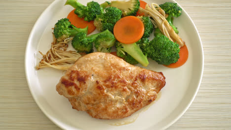 grilled chicken steak with vegetable on white plate