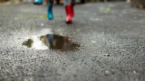 Children,-feet-and-jumping-in-water-puddle
