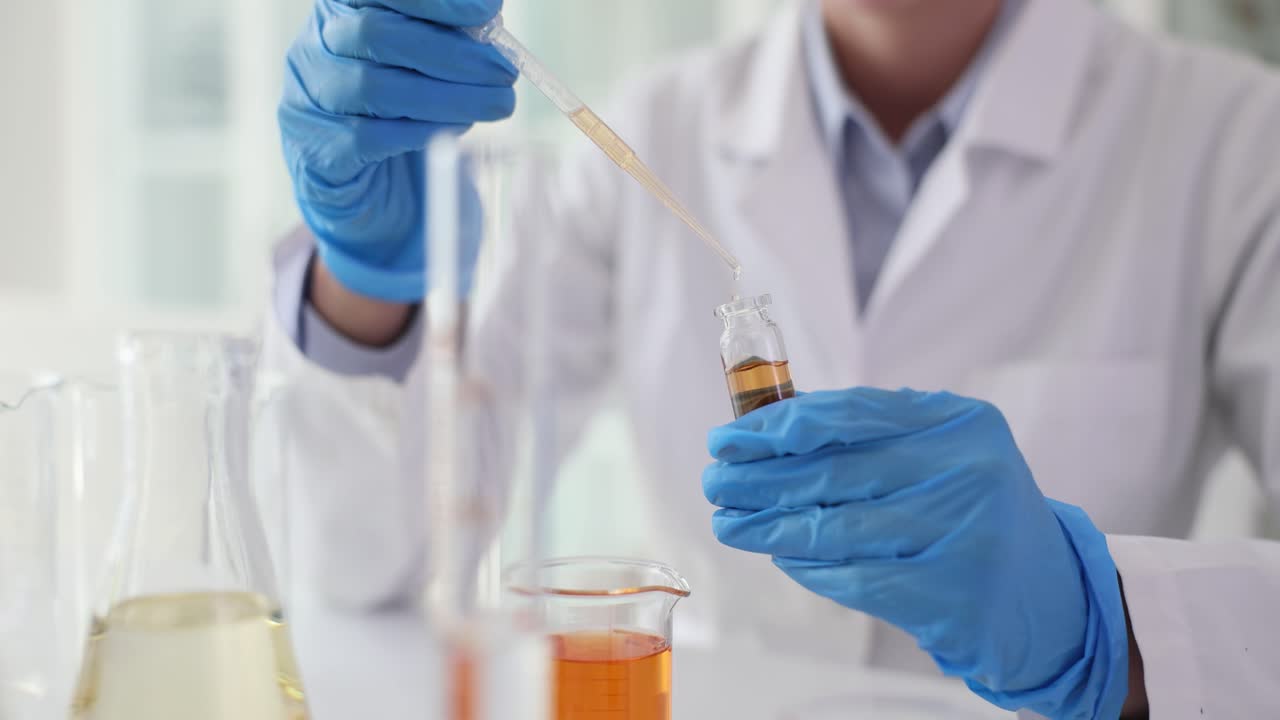 A scientist conducting a chemical experiment in a laboratory