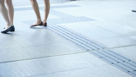 two women leaveing the building and going through glass doors