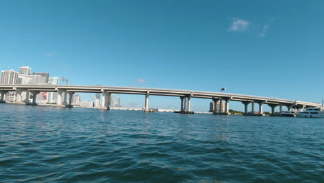 small boat pov as it approaches biscayne bay bridge miami florida