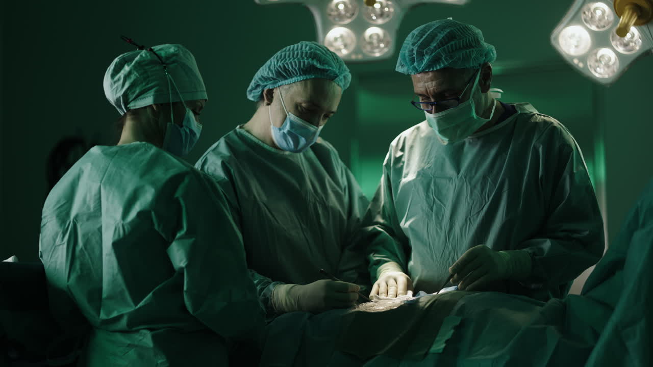 Surgical team performing operation in operating room