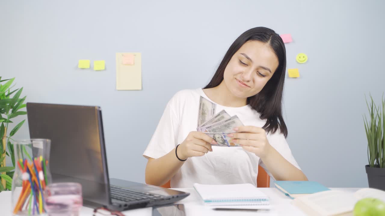Happy Female student earning money.