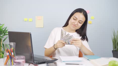 happy female student earning money.