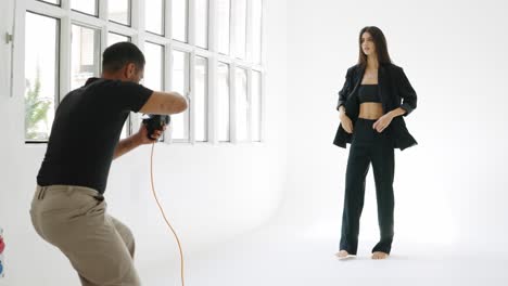 Fashion photoshoot with a model and photographer in a studio