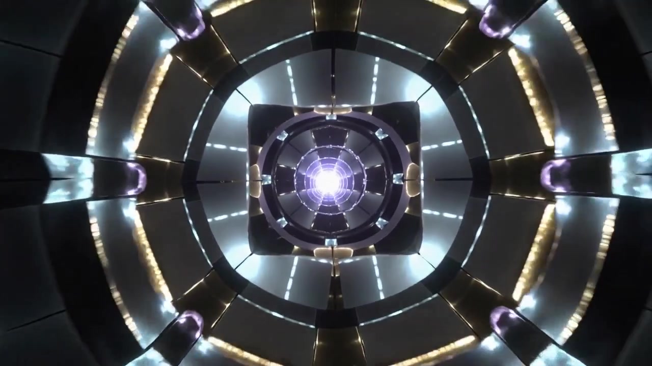 Avvio del programma di illuminazione, con un apparecchio di illuminazione centrale che cambia colori e rivela anelli segmentati in un condotto.
