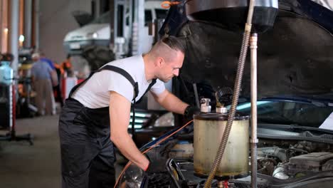 mechanic working on a car engine in an auto repair shop