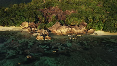 drone footage at sunset overlooking a beach on the island of la digue in the seychelles