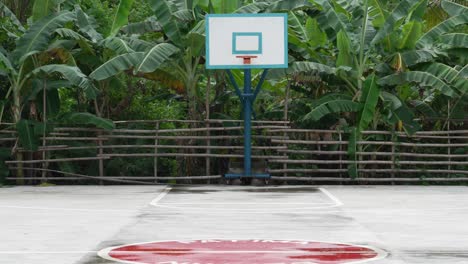 empty basketball court in the philippines with marked lines and vibrant red center