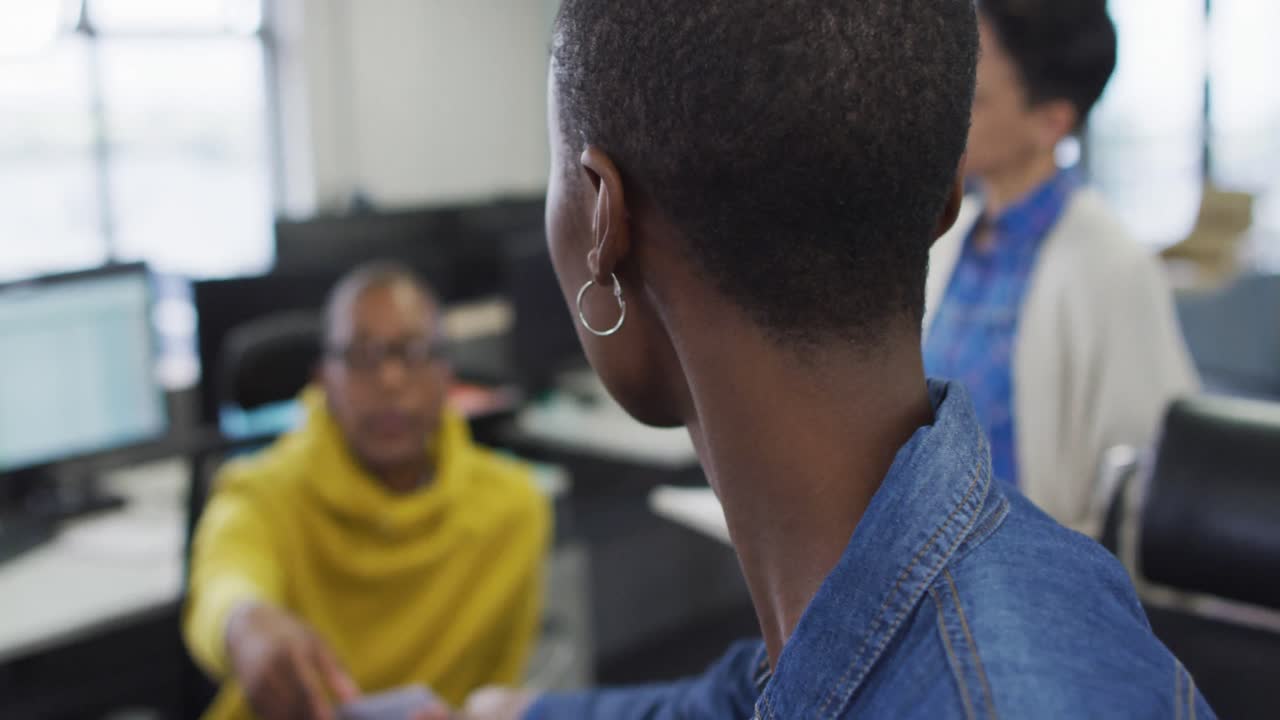 Diverse male and female business colleagues discussing in meeting in office