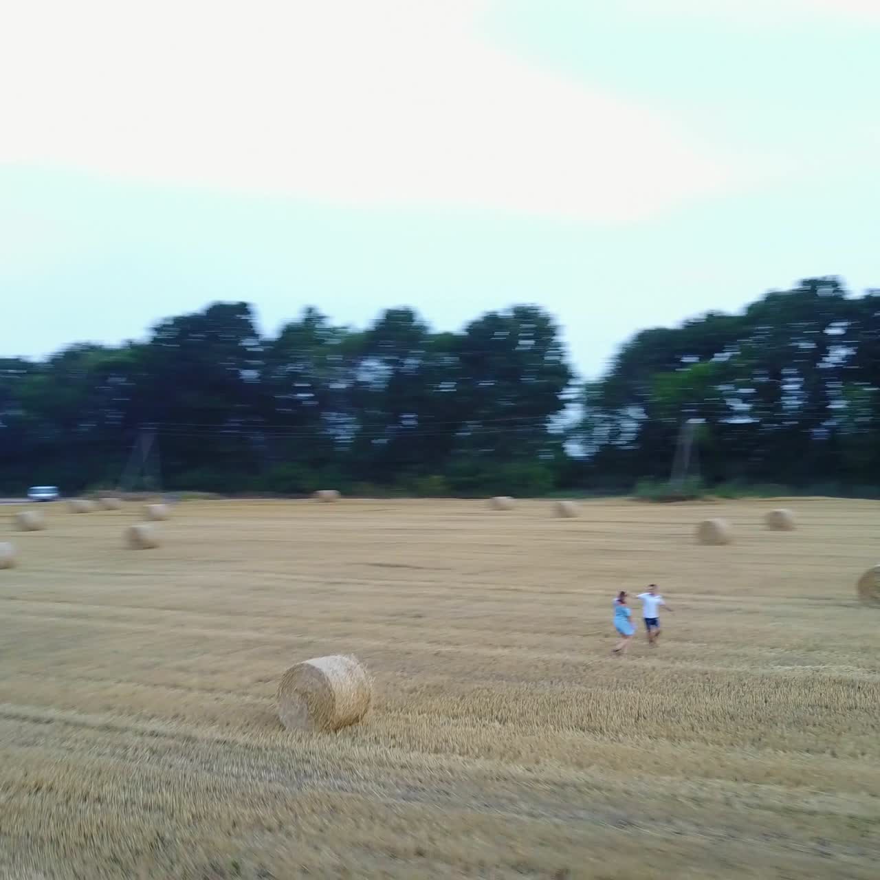 Couple Walking Near Haystack