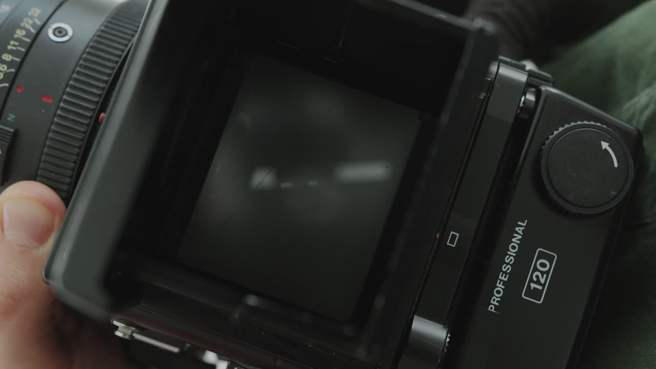 Hands of Photographer Reviewing Photos of Model on Camera Viewfinder