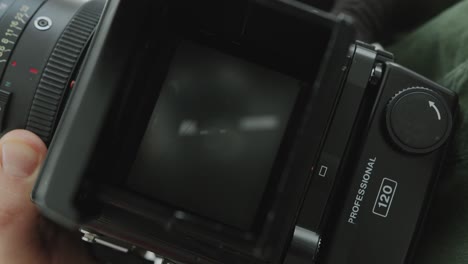 hands of photographer reviewing photos of model on camera viewfinder