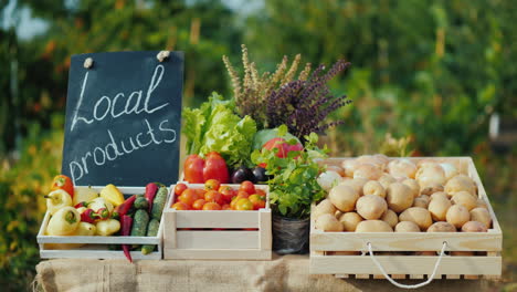 counter with fresh vegetables and a sign of local products