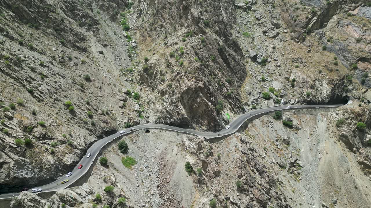 Dangerous mountain roads in arid Hindu Kush mountains bordering Pakistan, drone aerial