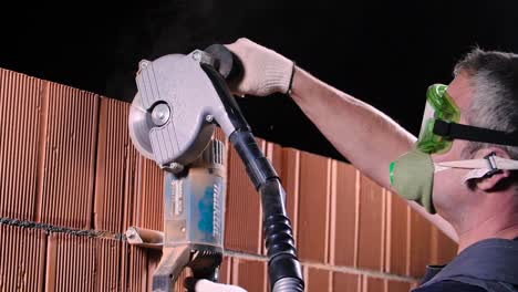 brick wall cutting with power tool and safety gear