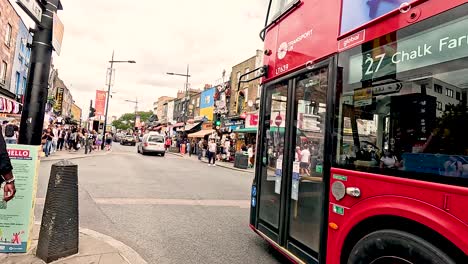 red bus passing through camden town, london