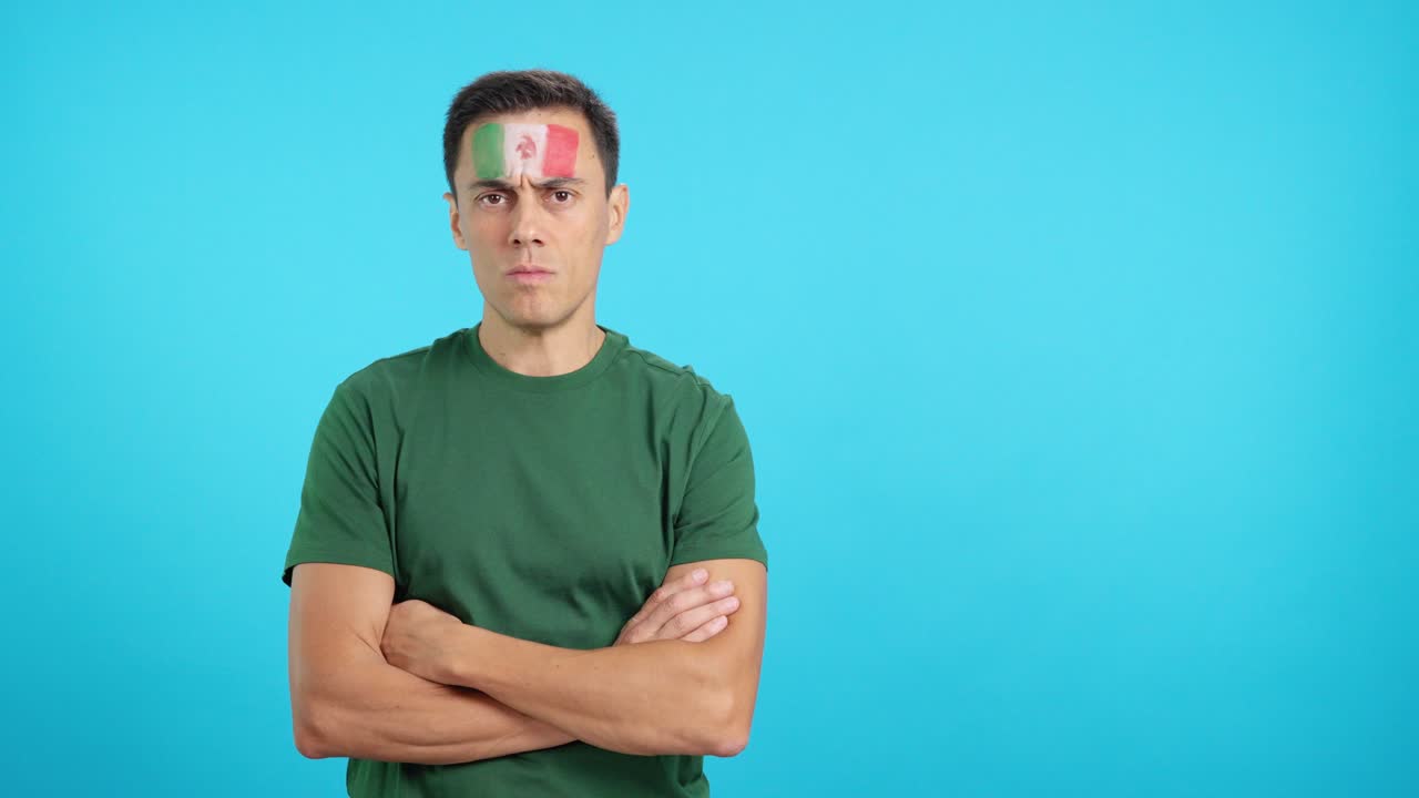 Dignified and serious man with mexican flag painted on face