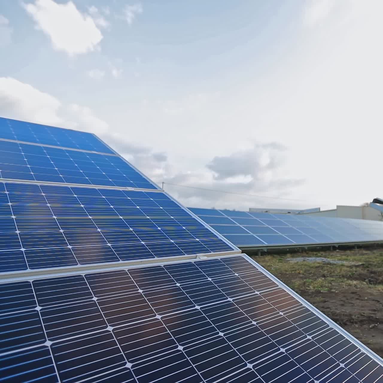 Sunny batteries on the field. Innovative equipment in electricity. Alternative green energy from solar panels. Sunny energy production plant.