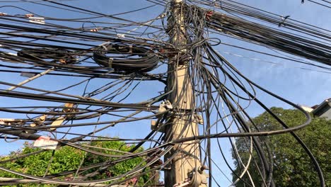 tangled cables and wires on a utility pole