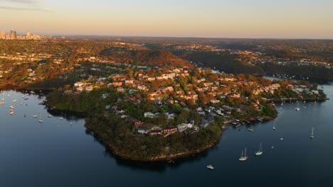 aerial view of luxury homes on a coastal bay at sunset