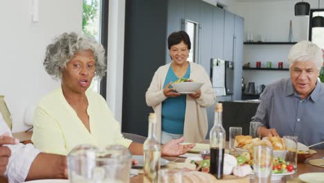 Happy-senior-diverse-people-having-dinner-at-retirement-home