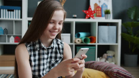 teenage girl using smartphone at home