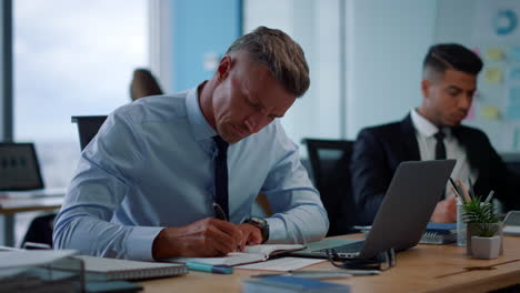 male entrepreneur typing on laptop at workplace