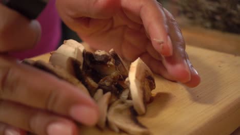 mushrooms slowly sliced on a cutting board