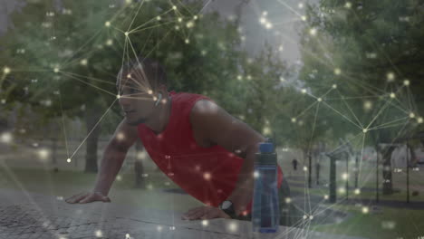 animation of glowing communication network moving over male athlete exercising outdoors