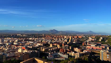 Above-view-of-the-Spanish-city-of-Alicante-during-the-day-with-clear-blue-sky-4K-30-FPS