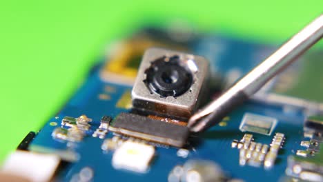 using magnetic screwdriver to replace the camera inside the smartphone