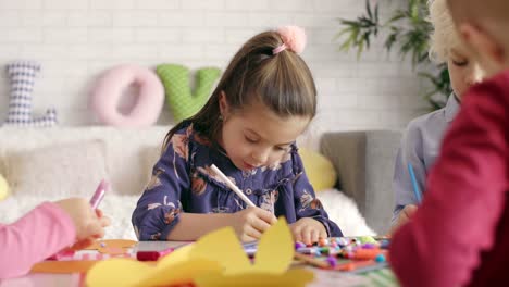 Close-up-of-focused-children-preparing-easter-decorations