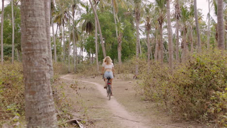 woman-riding-bicycle-exploring-tropical-island-girl-on-bike-enjoying-beautiful-palm-tree-forest-4k