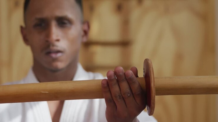 Close up view judoka holding a wooden saber