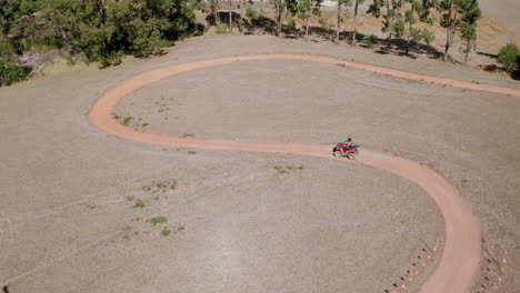 aerial view following atv on a quad bike track, in australia - tracking, drone shot