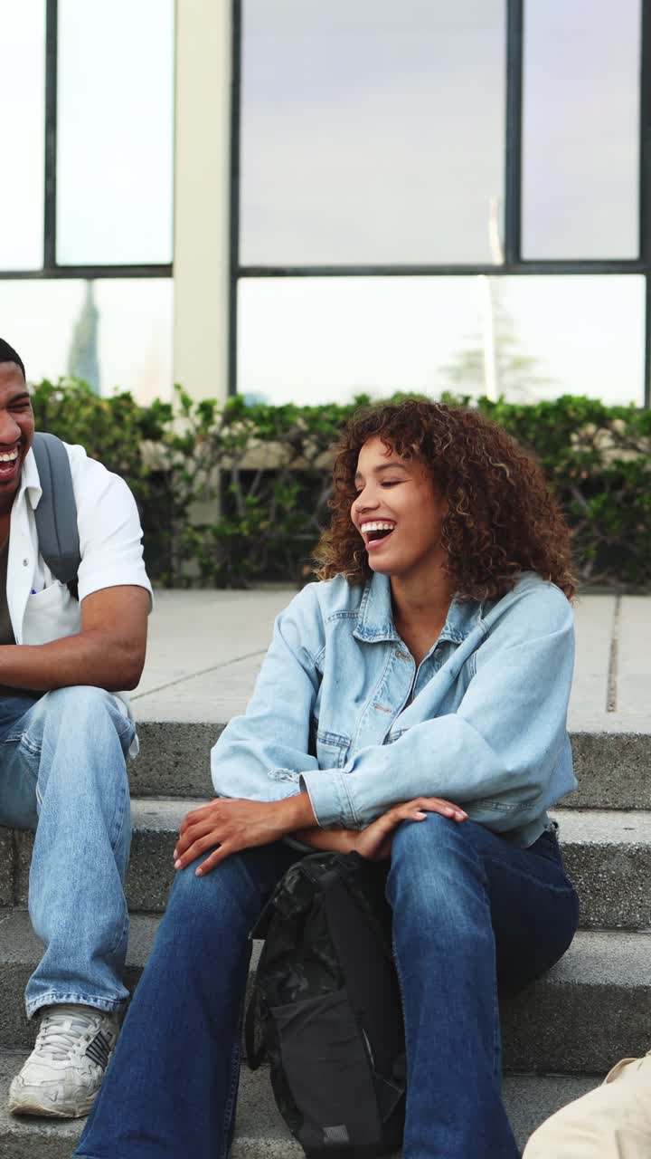 Happy Young Students Talking and Laughing on Campus Steps
